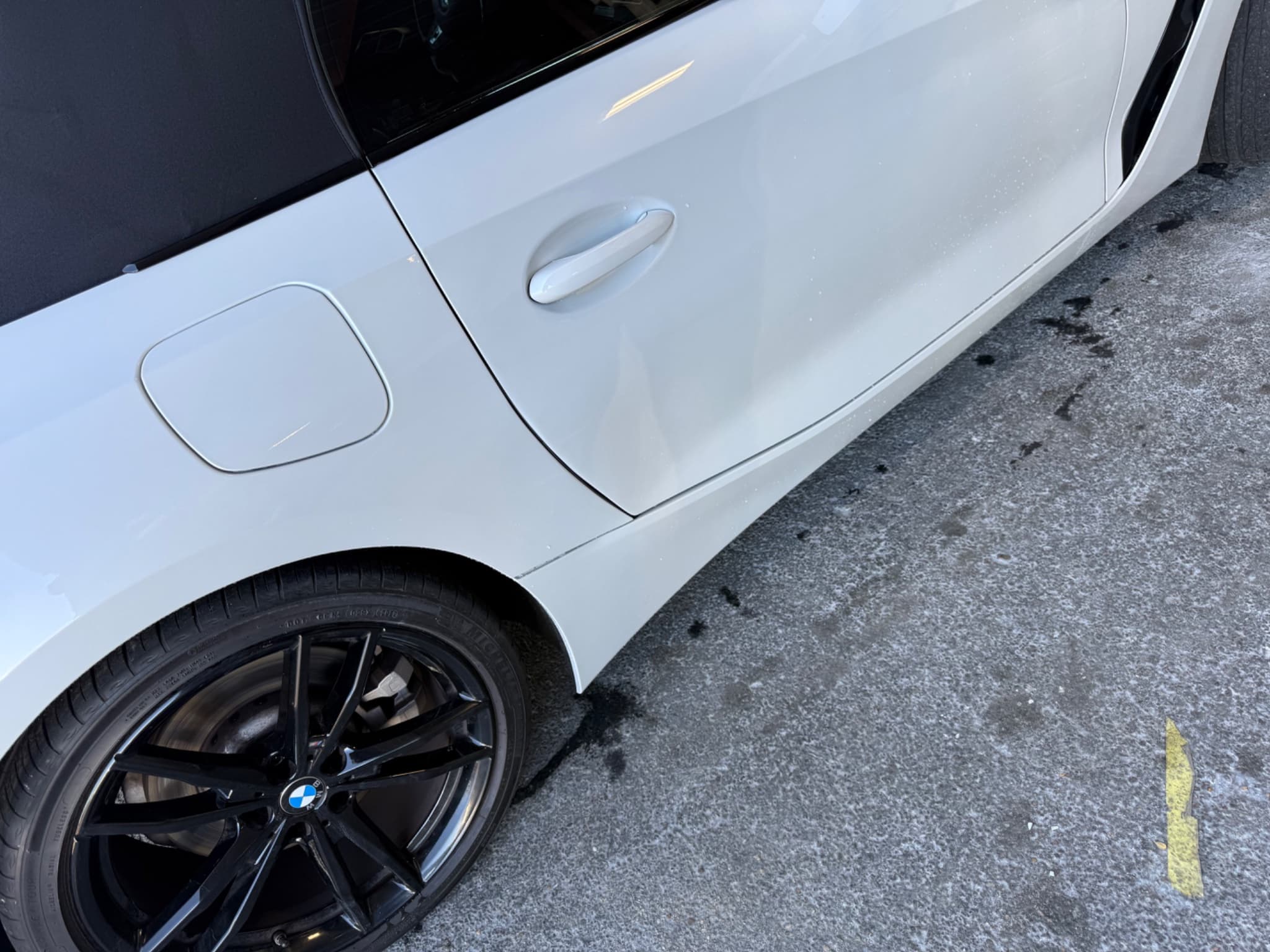 After: 2023 BMW Z4 pearl white quarter panel and door dent repair before and after in Austin TX